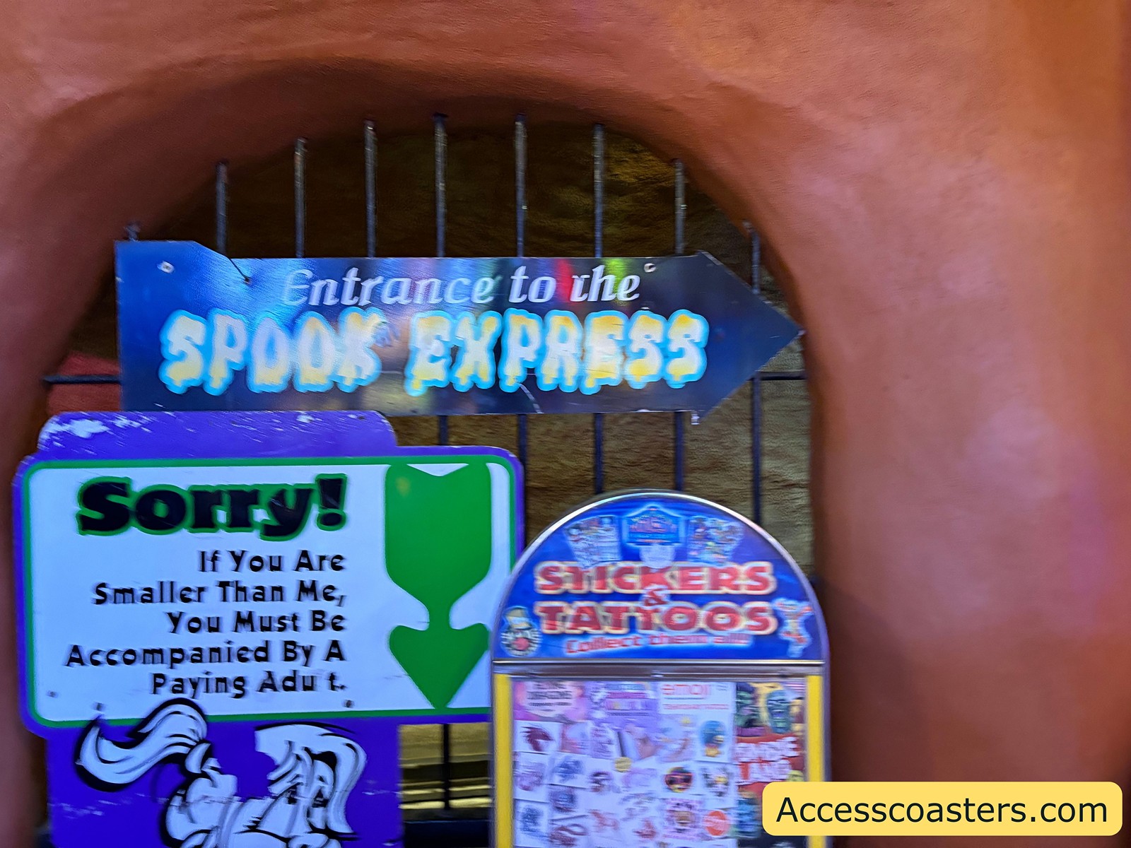 Close-up of the Spooky Express entrance signs, displaying safety information and height measuring instructions for children.