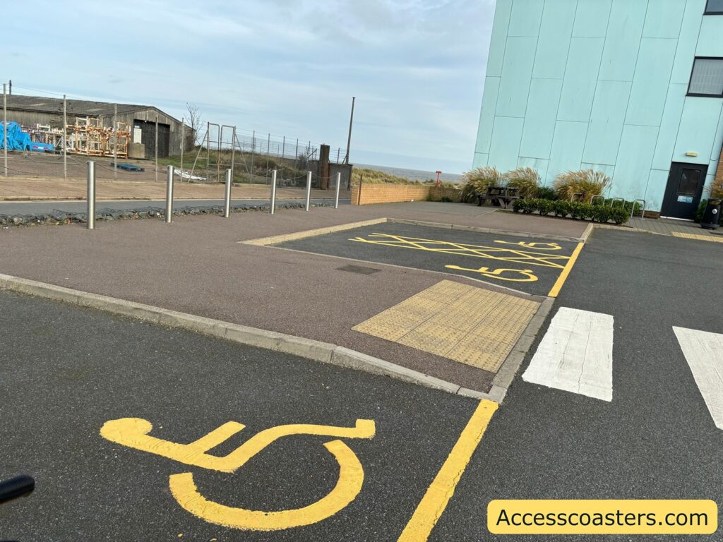 Allocated Blue Badge/disabled parking bays at the Pleasure Beach car park, featuring clear markings on the level ground.