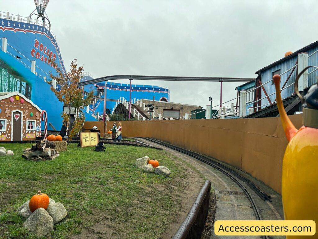 Outdoor scene of the Snails & Fairy Tales ride, showing snail ride vehicles traveling along a winding track bordered by colorful decorations.