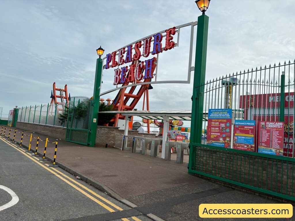View of the main entrance to Great Yarmouth Pleasure Beach, with a large Pleasure Beach sign and visible entrance gates
