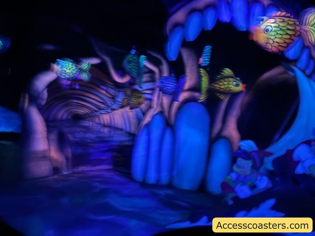 A UV-lit indoor scene with glowing fish