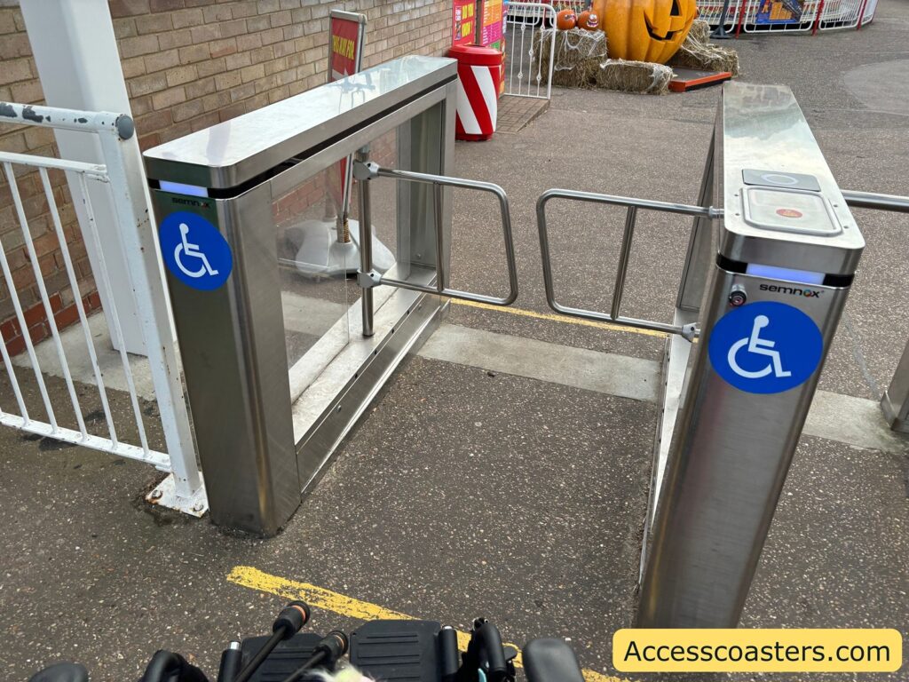 Close-up of the wheelchair accessible entry gate at Great Yarmouth Pleasure Beach, marked with blue wheelchair symbols.