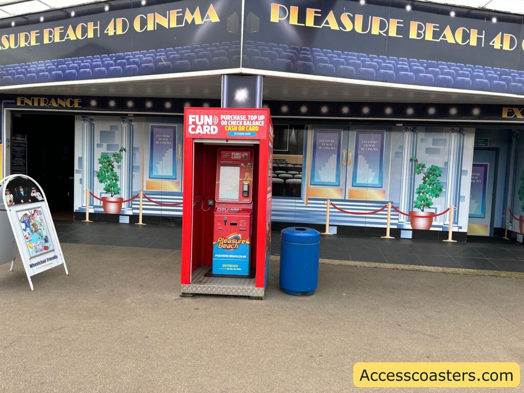 A red self-service kiosk labelled “Fun Card” stands outside an amusement park cinema called "Pleasure Beach 4D Cinema." This kiosk is where visitors can buy or top up their Fun Cards.