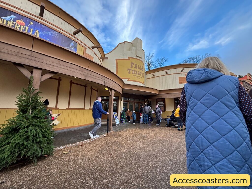 Outside view of the Falls Theatre entrance, with families and children arriving for the Cinderella Pantomime.