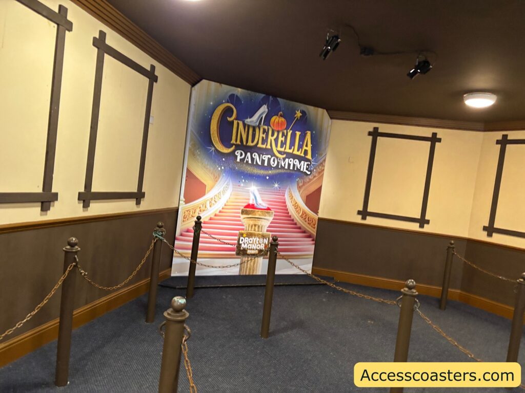 Inside the theatre’s waiting area, showing a “Cinderella Pantomime” banner near the entrance to the theatre 