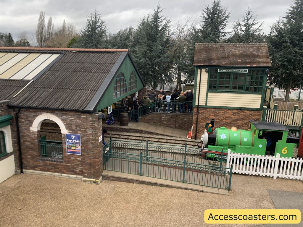  View of the accessible Thomas Land train station area at Drayton Manor, with visitors gathered and ramp access visible.