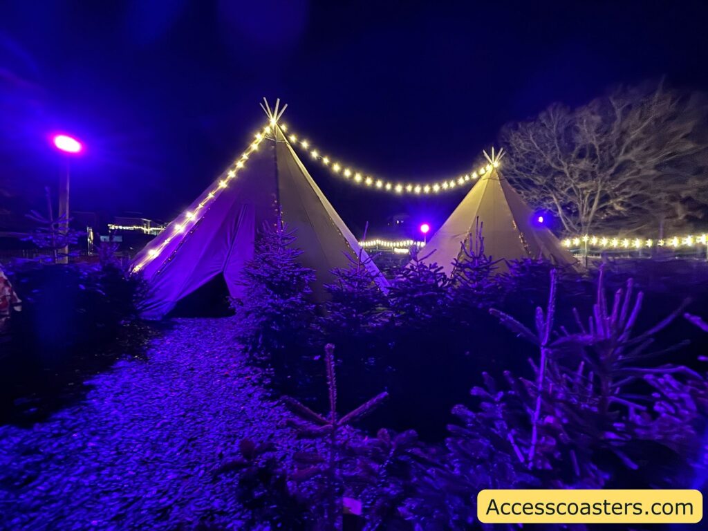 A pair of outdoor tents decorated with strings of warm white lights