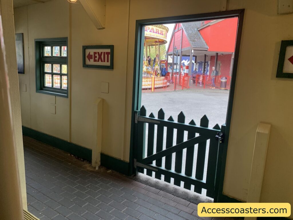 Interior view of the train station with a gate leading outside 