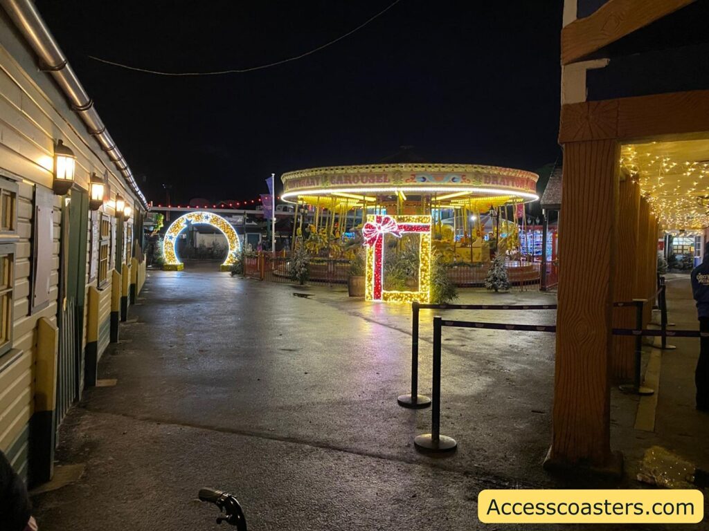 twighlight express entrance at night time with lights carosel in shot