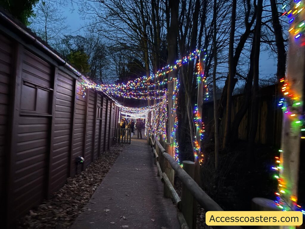 . Long tunnel walkway draped overhead and beside with white twinkle lights