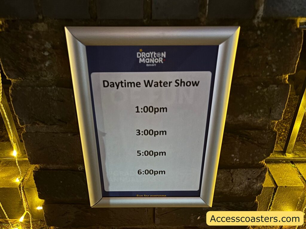 sign displaying "Daytime Water Show" schedule times at an event.
