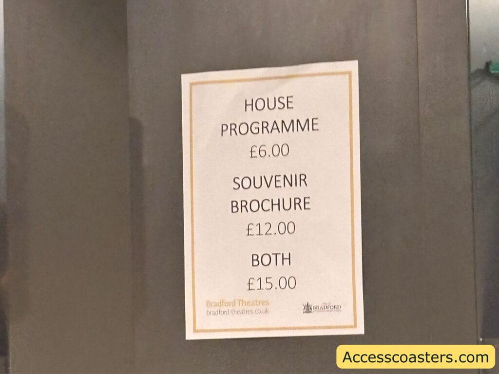 Close‑up of a framed price list on a theatre wall showing costs for the house programme, souvenir brochure, and a combined option.