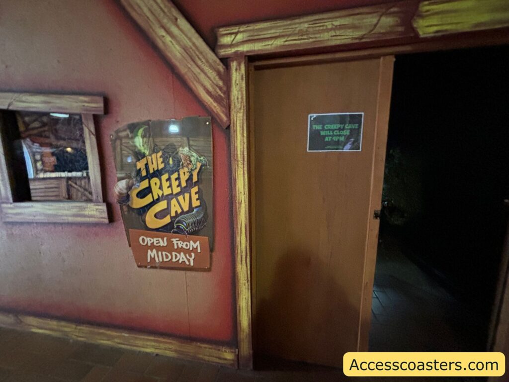  Close-up view of the Creepy Cave sign next to the entrance door.