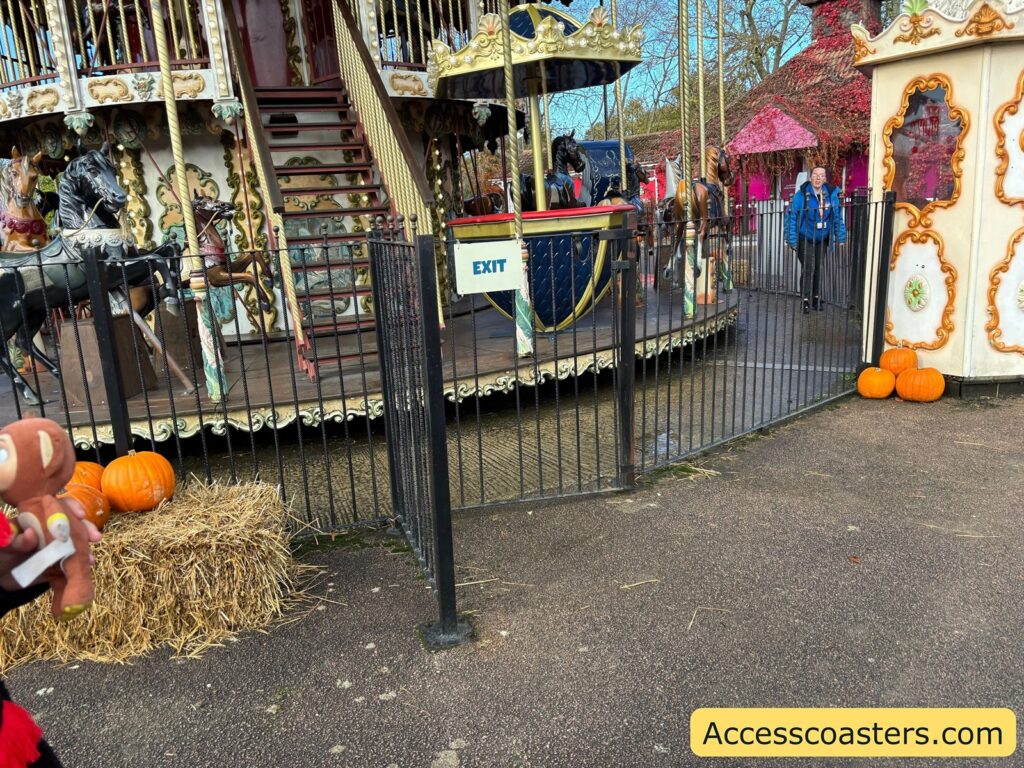 ride access pass Entrance area and ride exit of the Carousel ride at Pleasurewood Hills, enclosed by black fencing