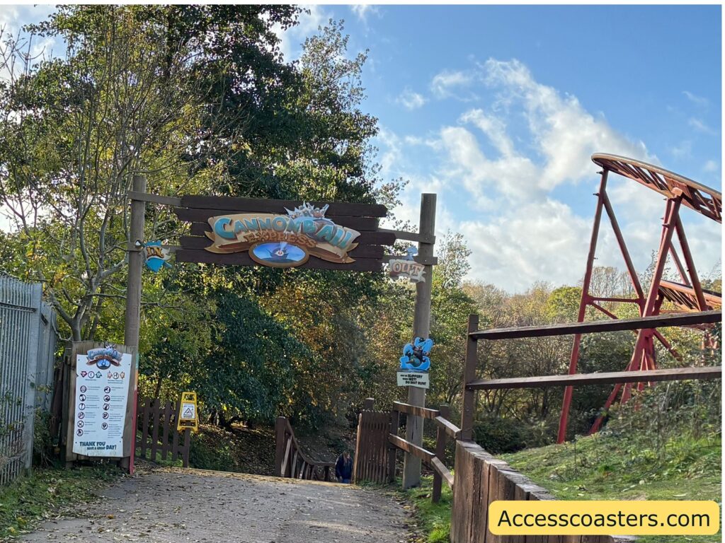 Entrance to the Cannonball Express roller coaster, showing the ride’s track and signage with ride restrictions
