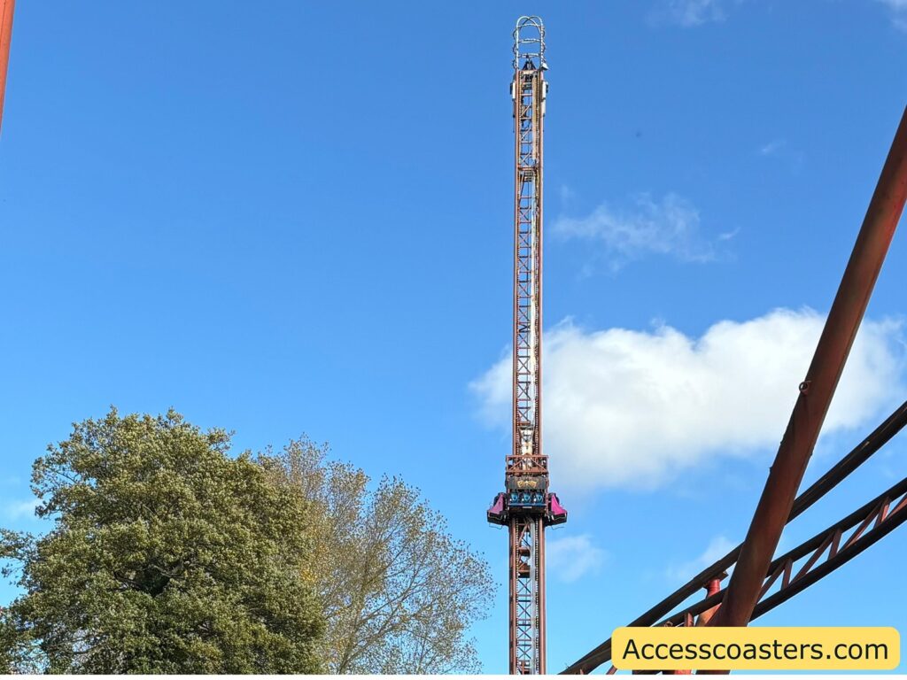 Jolly Roger drop tower ride structure seen against a blue sky,