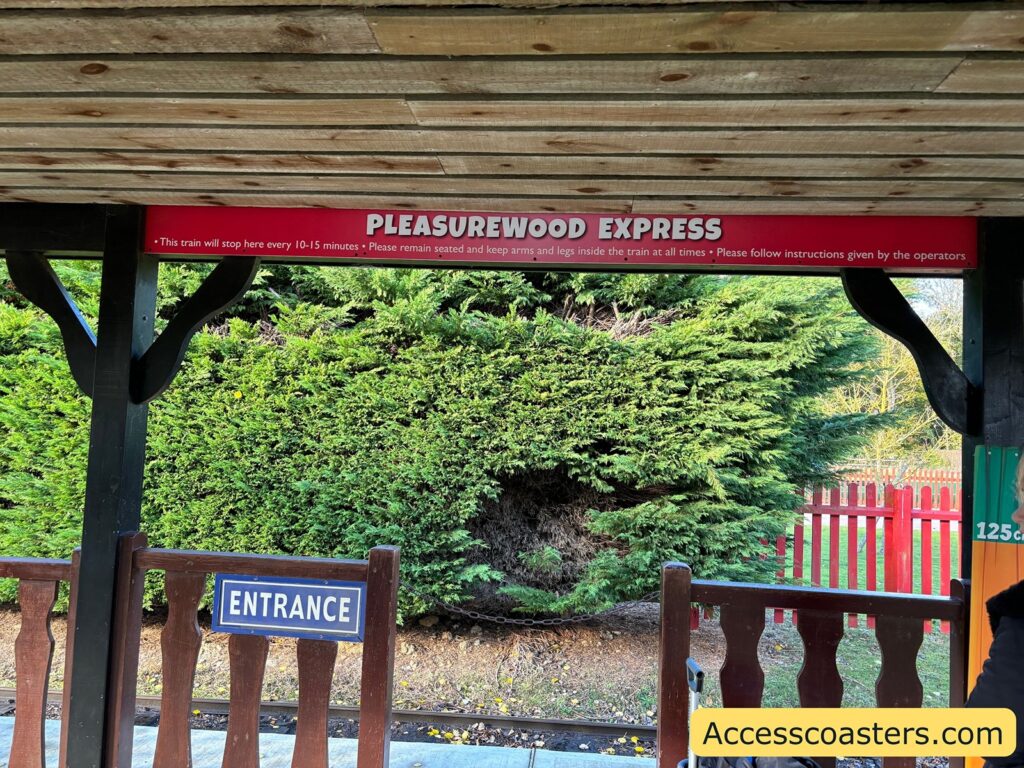 Entrance to Pleasurewood Hills Express with a red sign above a gated entryway.
