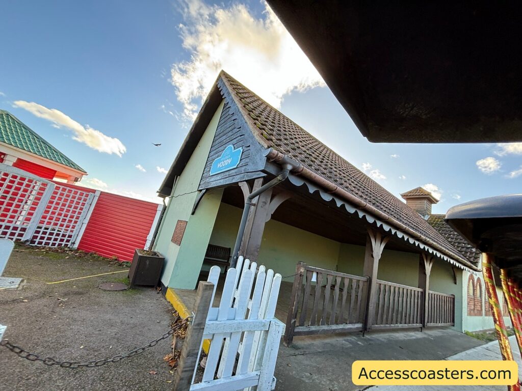 Building at the Pleasurewood Hills Express station with a covered waiting area and white fence.