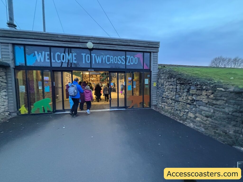 Entrance doors with a “Welcome to Twycross Zoo” sign as visitors walk inside for the light trail event.