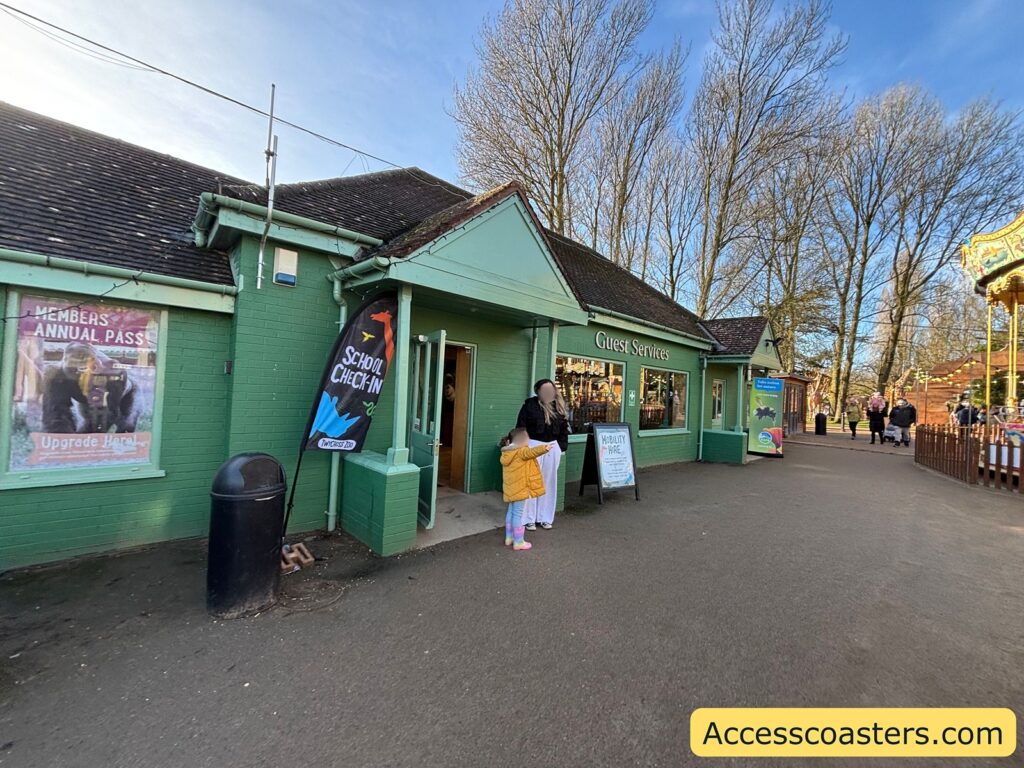 Green Guest Services building just past the entry booths, where visitors can collect hired mobility aids and pick up maps.