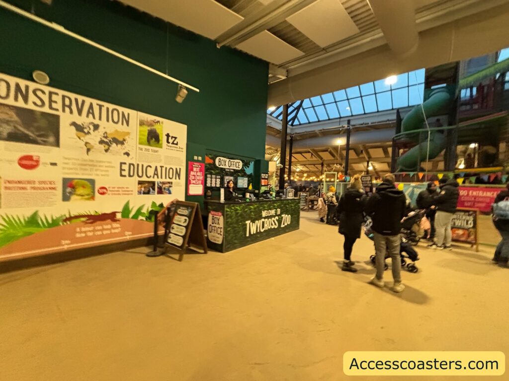 Indoor lobby at the Himalaya Centre with conservation and education displays as visitors head toward the event entrance.
