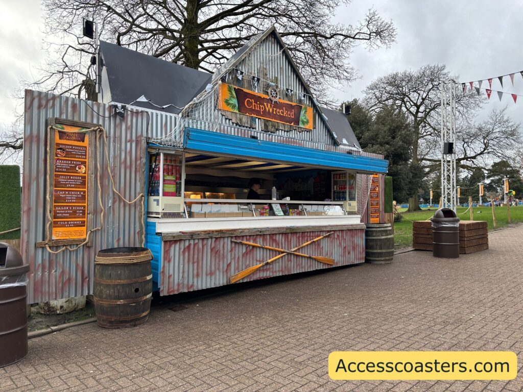 Chip Wrecked food truck on Towers Street, a corrugated-metal pirate-themed kiosk with a serving hatch, “Chip Wrecked” sign above the counter, and barrel props beside the stand.