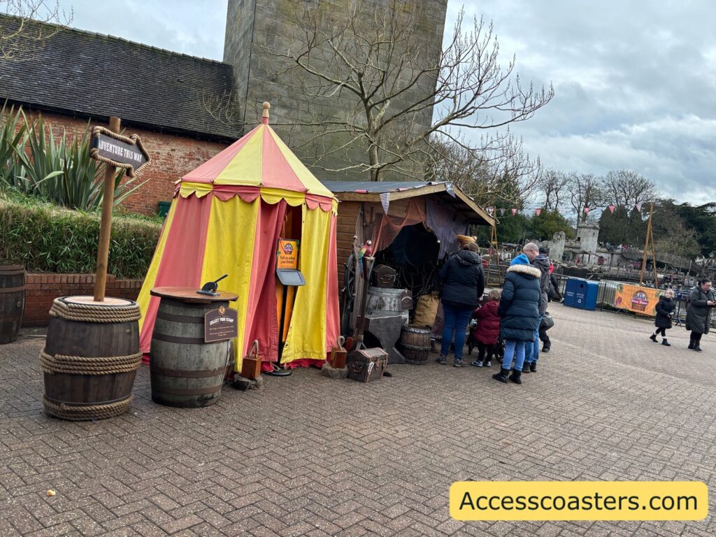 image of red and yellow tent next to a pirate hut with a pirate inside giving out prizes