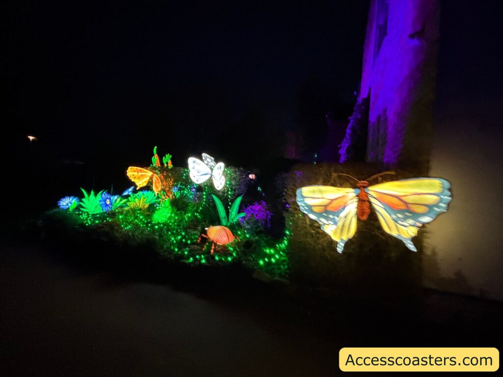 Nighttime African Forests butterfly light scene with illuminated butterflies hovering above bright green glowing plants beside a purple-lit tree trunk.