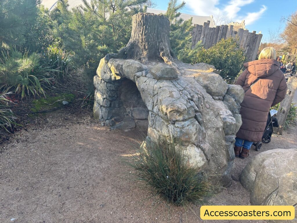 Wheelchair-accessible path beside a rocky “underground” den area,