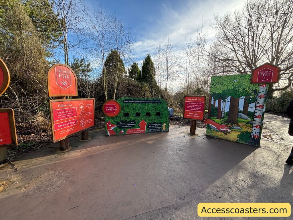 Outdoor area with several red information signs and activities 