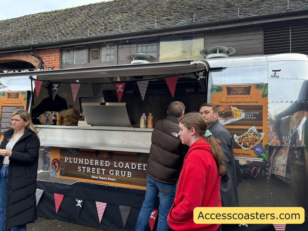 People queuing at a food truck in the Mutiny Bay courtyard during the pirate takeover event.