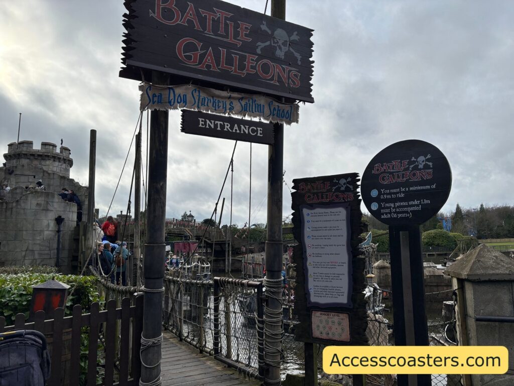image of the main entrance for battel galleons with a ride restriction board and hight chart