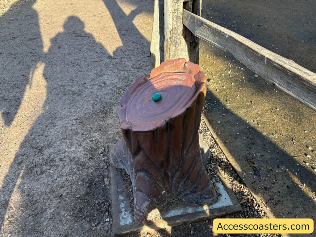 Wooden stump-style activator post with a green button on top, used to start the Fox animatronic story audio.
