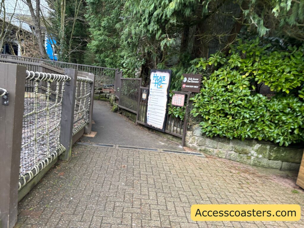 entrance path to the ride exit and ride exit pass entrance with a ride restriction board and ride access pass qr code