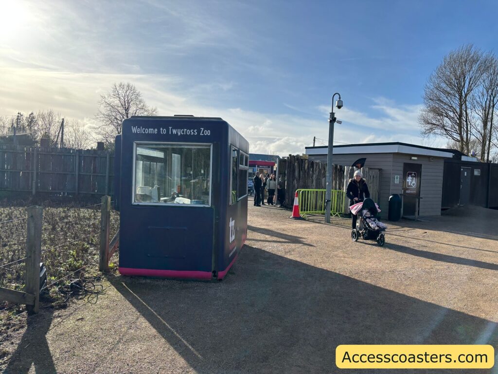 Small entry or information booth beside the walkway near the entrance area.
