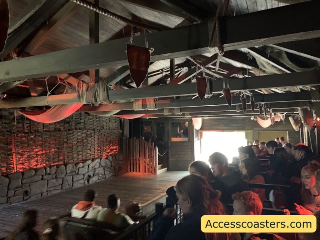 wickerman ride station with trail coming into the station and people waiting in the air gates.