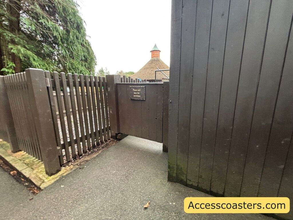 ride access pass and exit gate for heave ho with a sign that reads please wait here for assistance