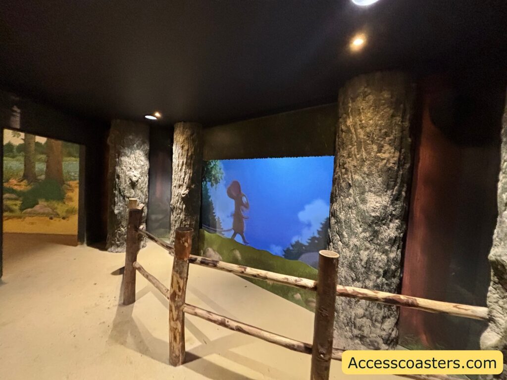 ndoor Owl area with tree-trunk pillars and a large screen