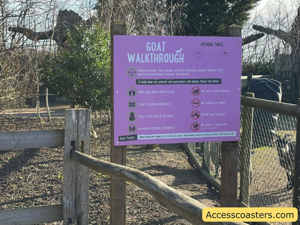 Purple “Goat Walkthrough” rules sign fixed to a fence at the entrance