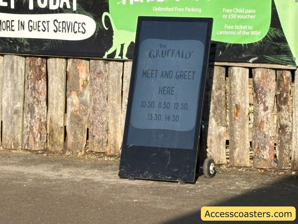 A-frame sign in front of a wooden wall reading “The Gruffalo meet and greet here,” with times listed: 10.30, 11.30, 12.30, 13.30, 14.30, 15.30.