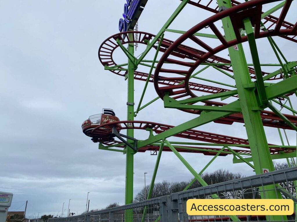 Fifth image (bottom middle)
Side view of the Spinning Coaster layout, with green supports and red track weaving in tight turns and small drops 