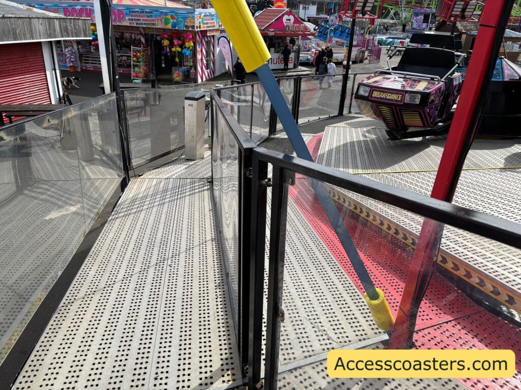 Metal ramped queue line leading up to the Breakdance ride platform 