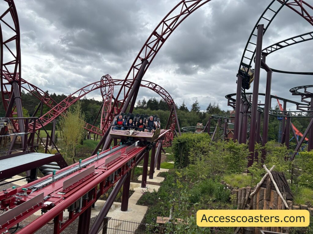 image of Drakon train with people in on the break run. Next to the breakrun you can see the Raven ride. 