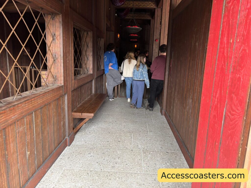 image of Drakon queue assist station wating area with a wooden bench and people waiting in the corridor. 