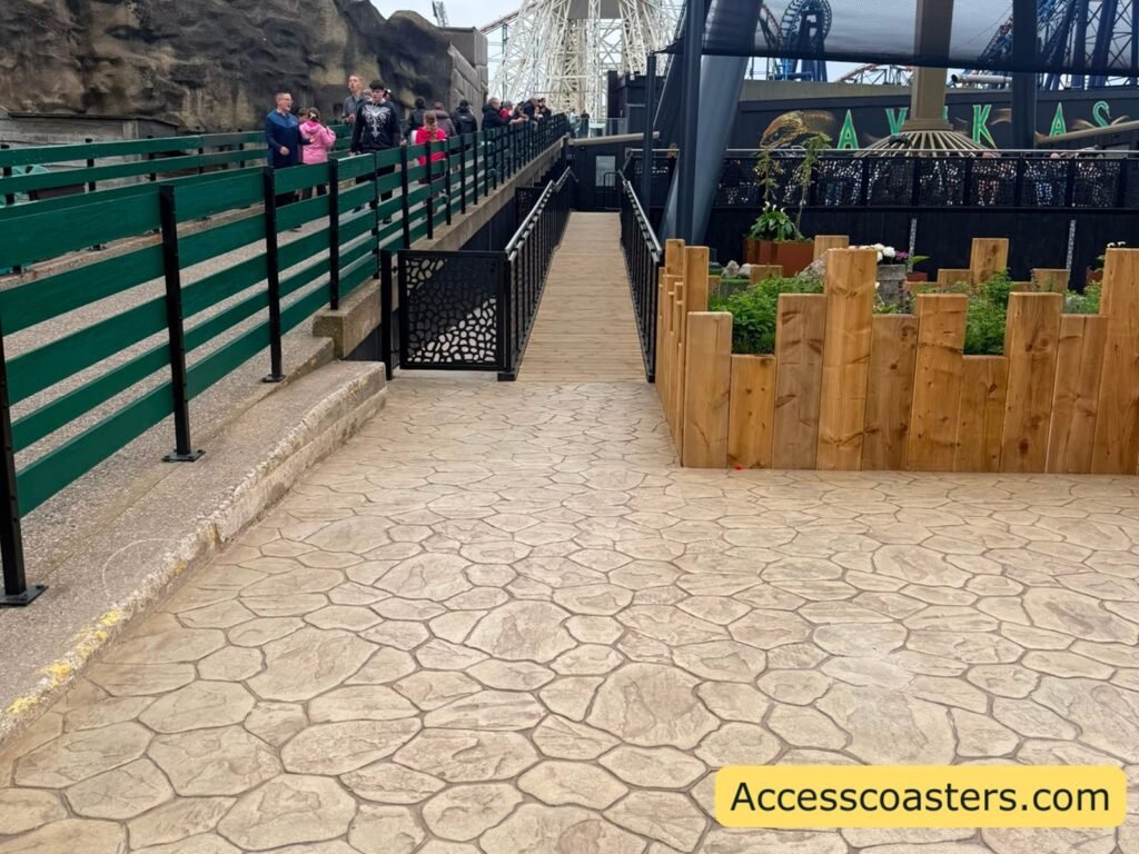 small incline paved exit ramp with black railings and silver handles