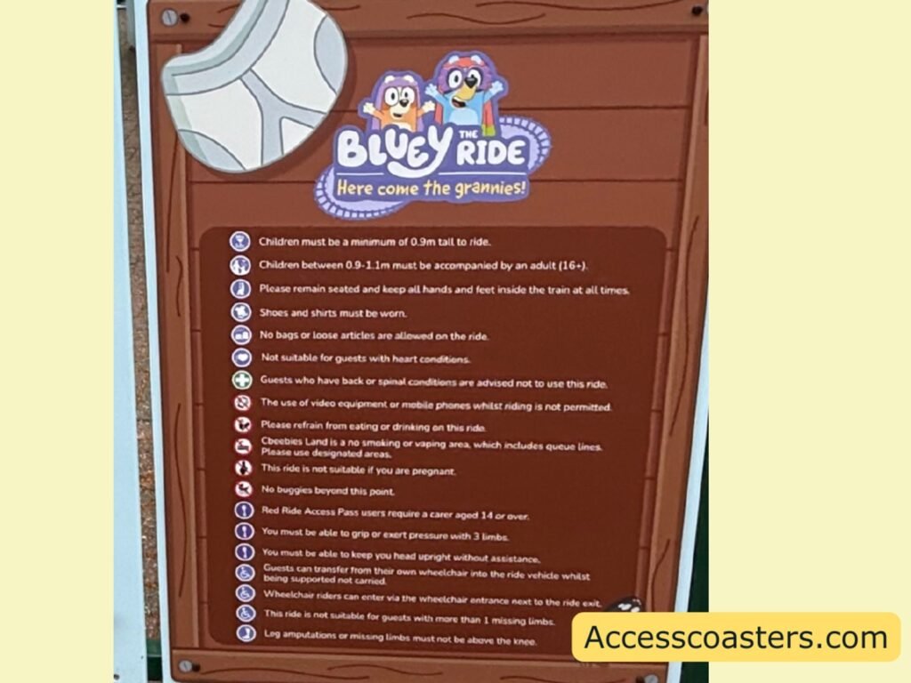 image of ride restriction board for bluey the ride. the sign is themed to a garden fence with a pair of pants on the corner of the sign. restriction on sign include no loose articles, no eating and drinking, not suitable for pregnant people, no buggies beyond this point and not suitable for heart conditions and back problems