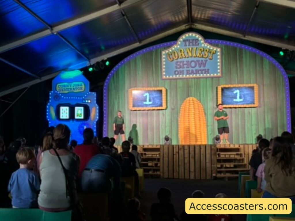 image shows the screens on the show both displaying a number 1 with both hosts waving arms to encourage higher or lower with 2 playing cards on the corniest joke generator. 