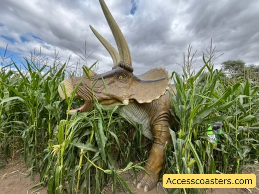 image of dinosaur statue  in the  maze hedging looking like its coming out 