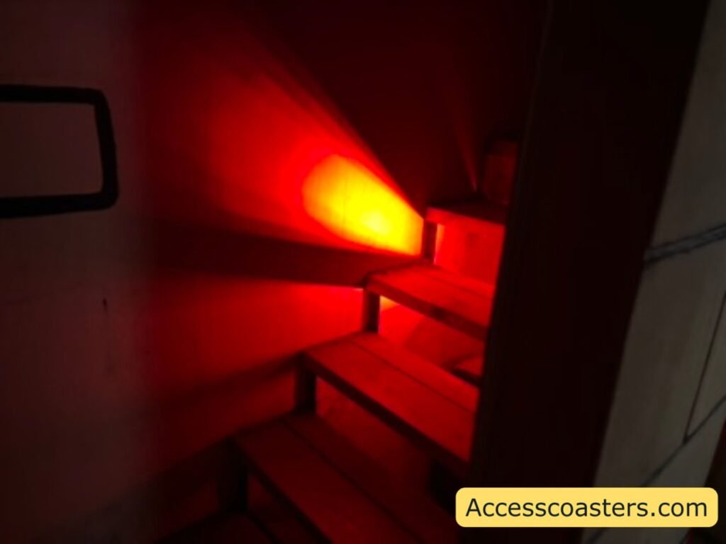 image of set of wooden stairs in a dim lit room with a red light