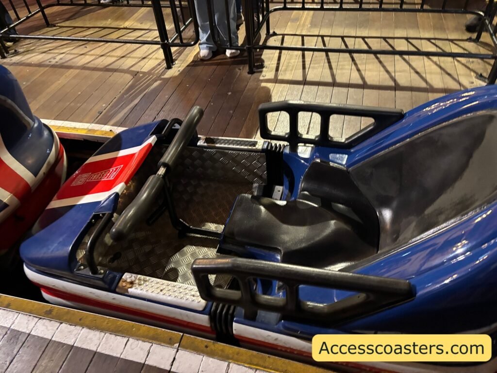 Close‑up of Avalanche bobsled coaster car in the station, showing the two inline seats where the rear seat has a backrest and the front seat does not